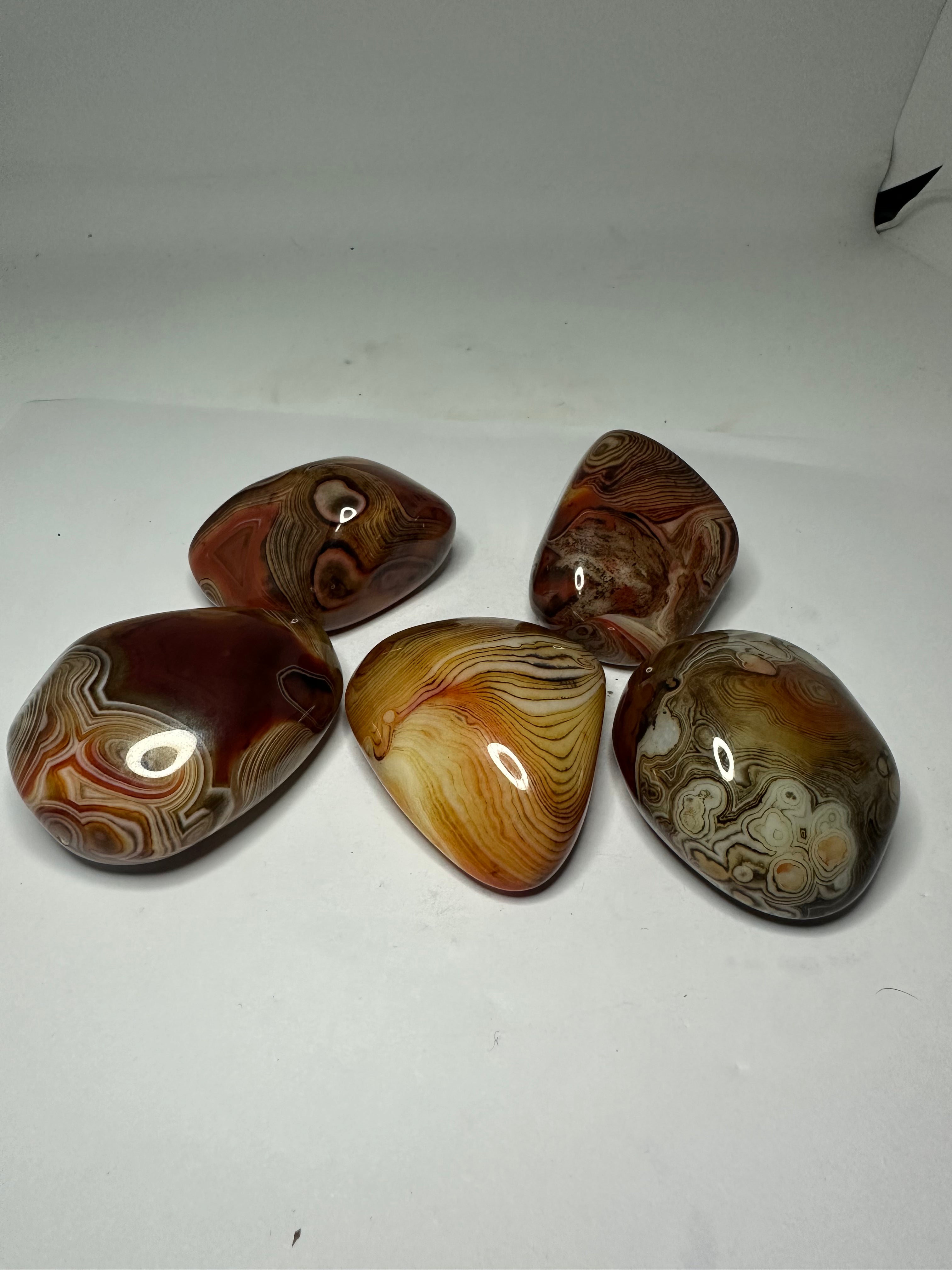 Polished sardonyx palm stone, 85-95g, shown from another angle