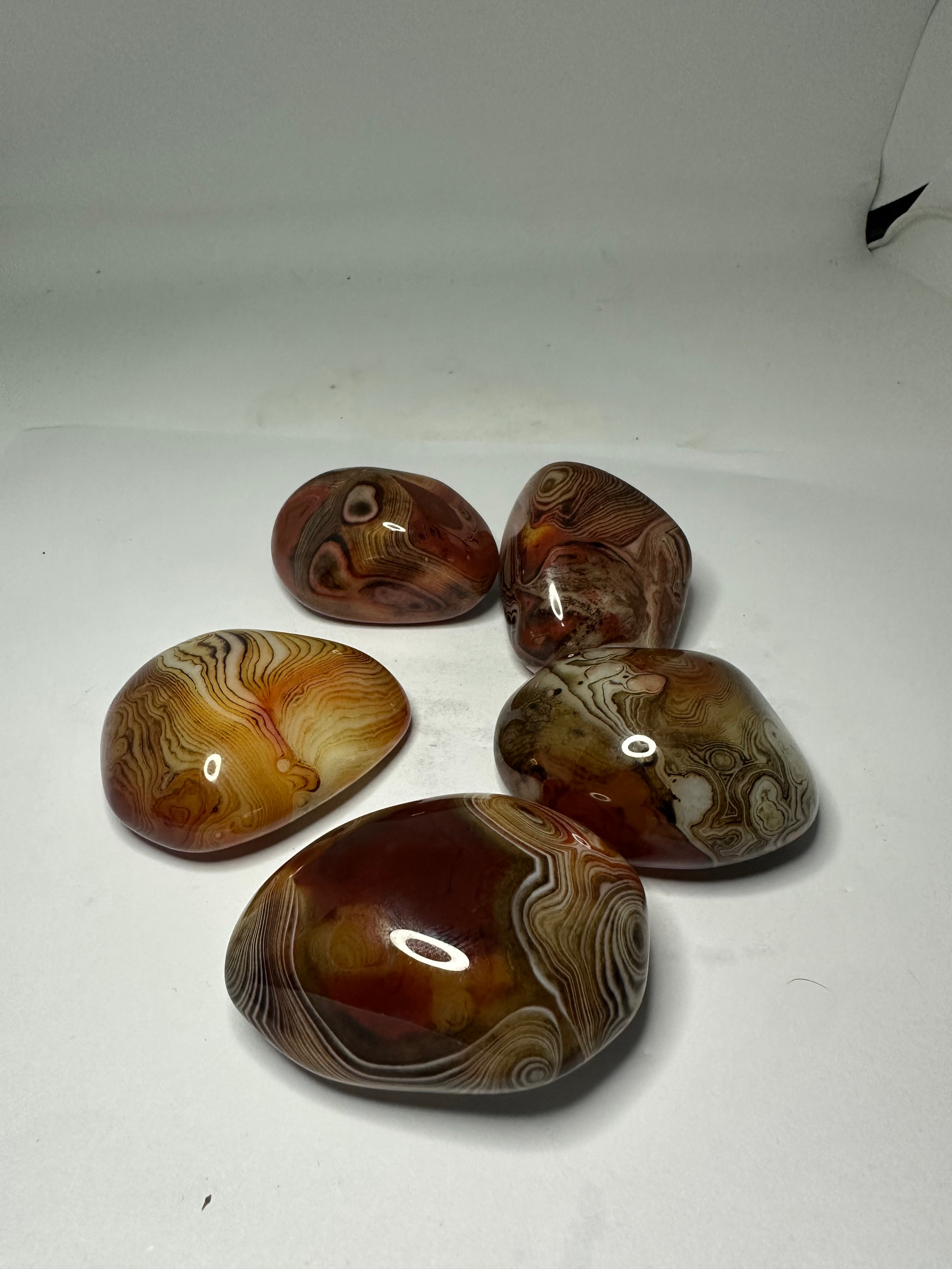 Polished sardonyx palm stone, 85-95g, shown from another angle